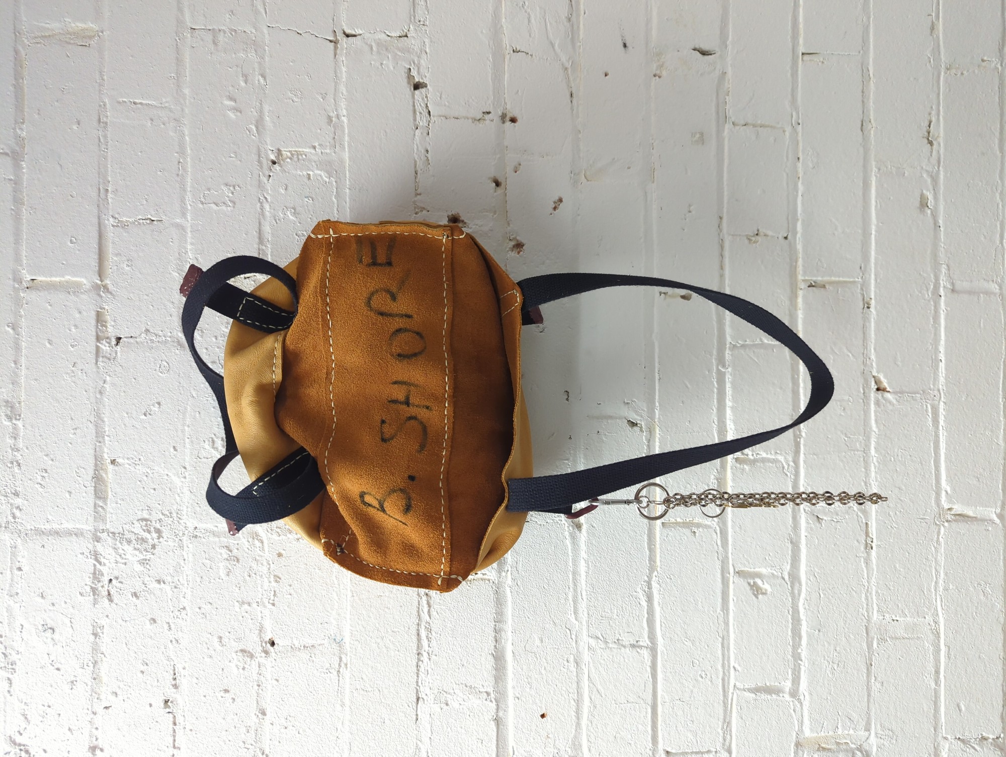 deerskin leather tote bag with rose petal dust suspended in resin coated hardware