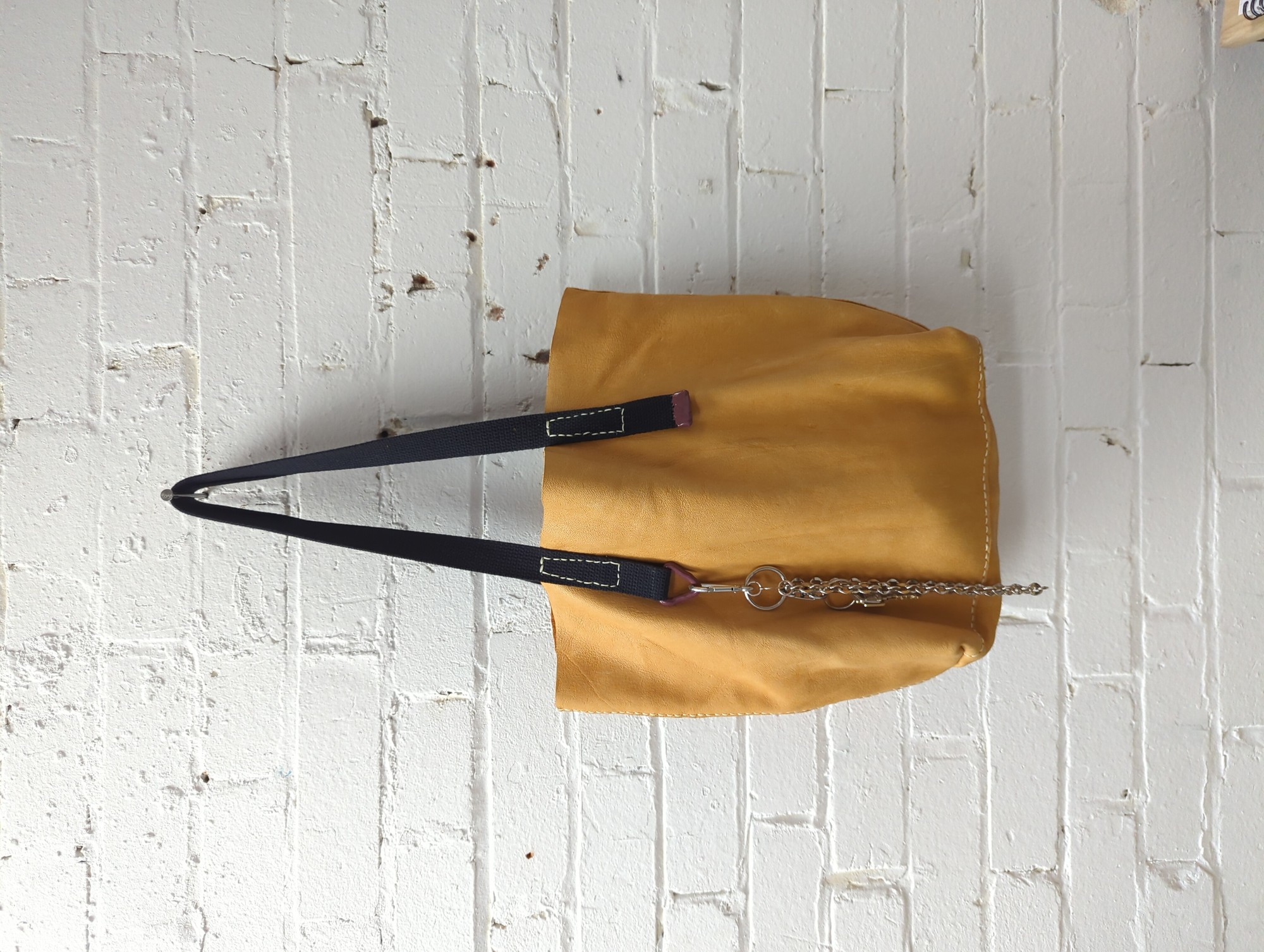 deerskin leather tote bag with rose petal dust suspended in resin coated hardware
