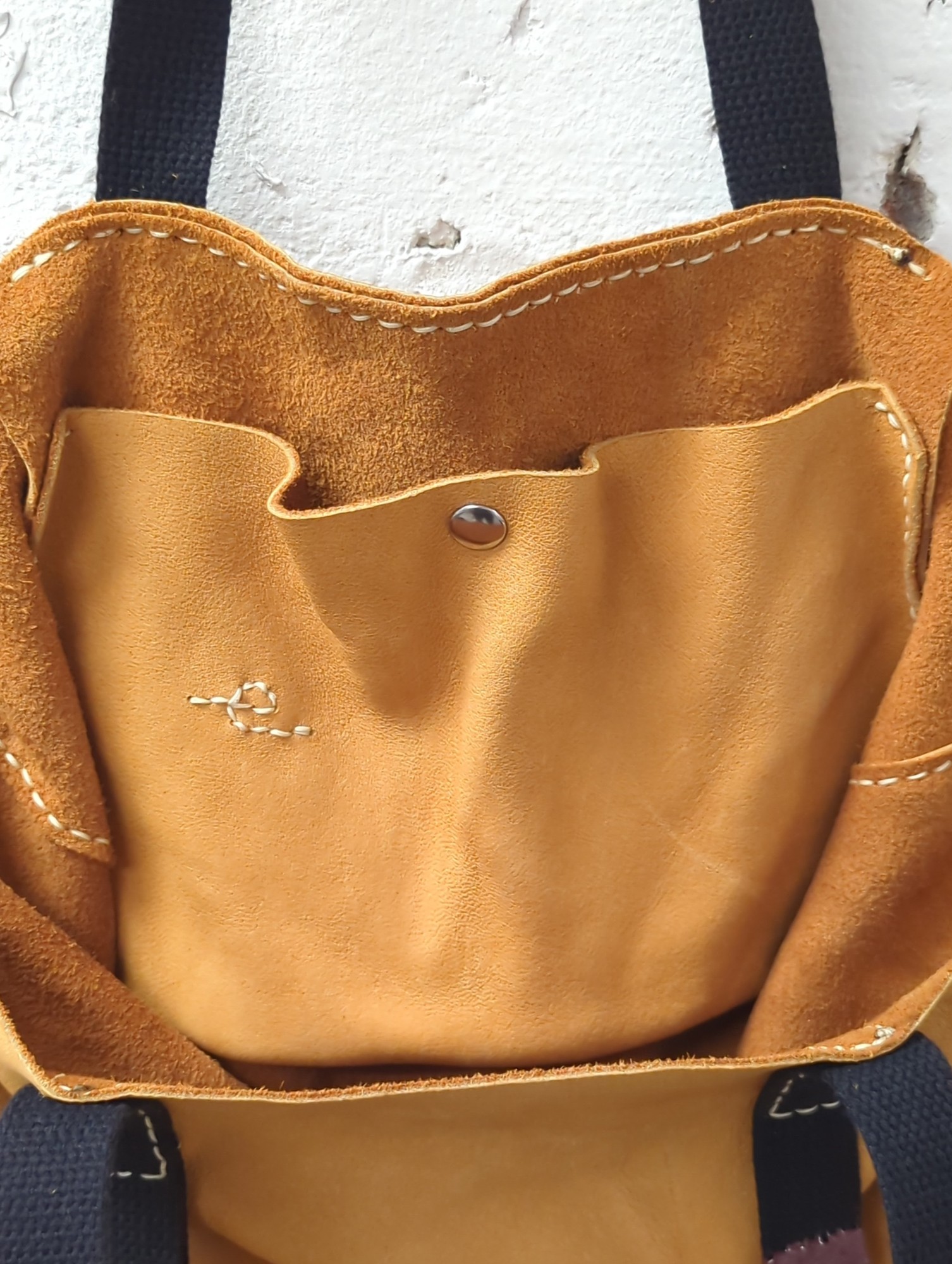 deerskin leather tote bag with rose petal dust suspended in resin coated hardware
